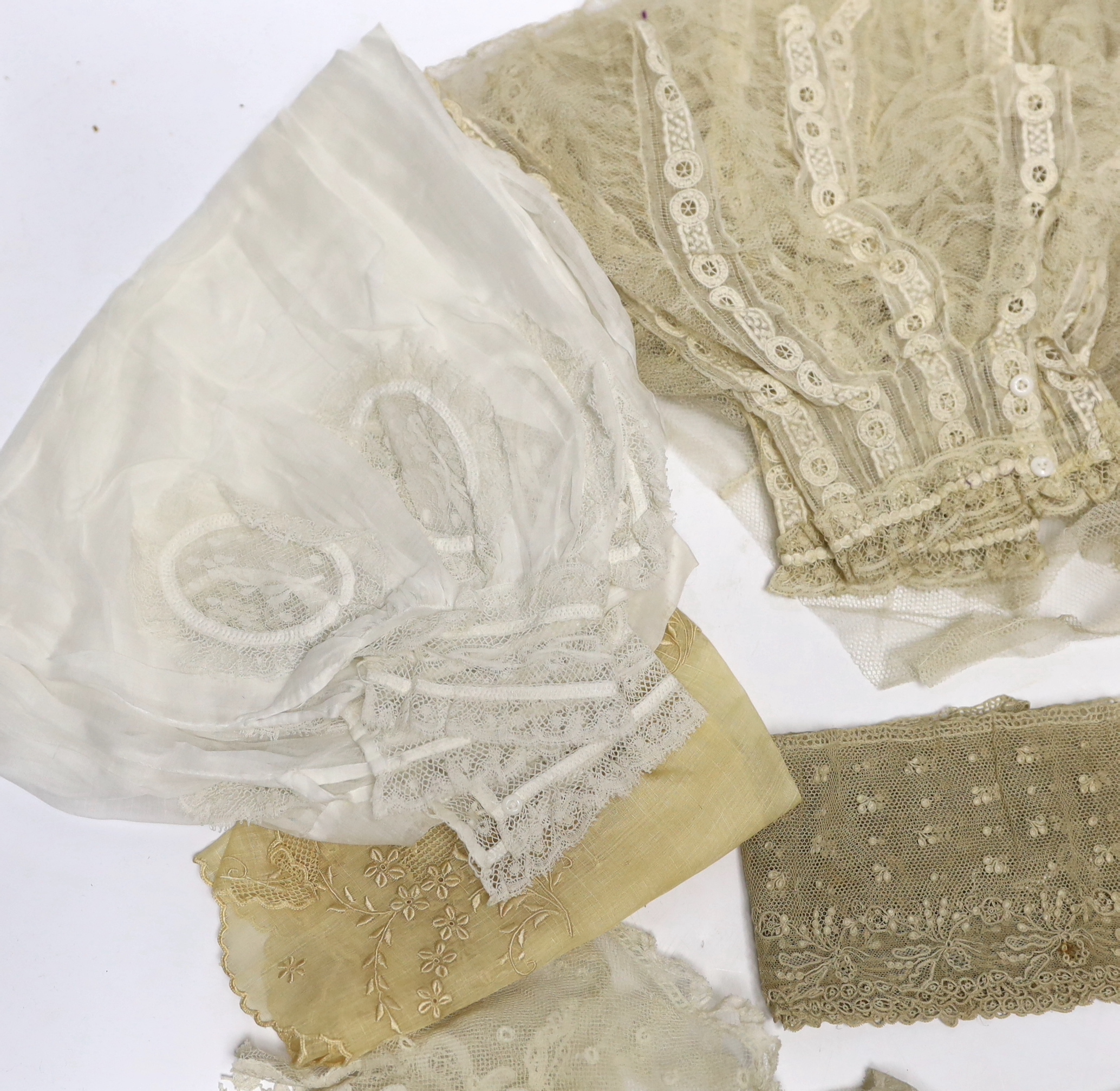 A collection of mostly 19th century French and English needle and bobbin lace trimmings, white worked sleeves, a black silk stole and black lace trimmings etc